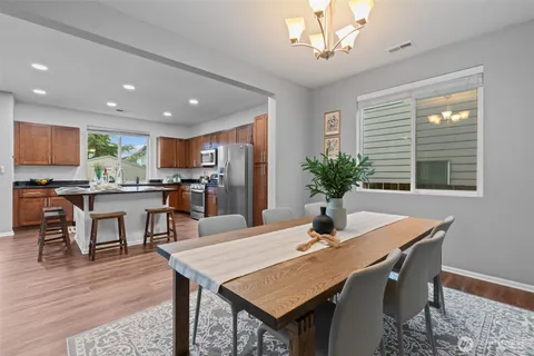 a dining room with furniture a window and wooden floor