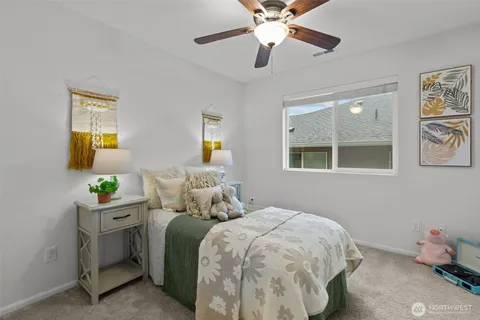 a bedroom with a bed and a chandelier fan