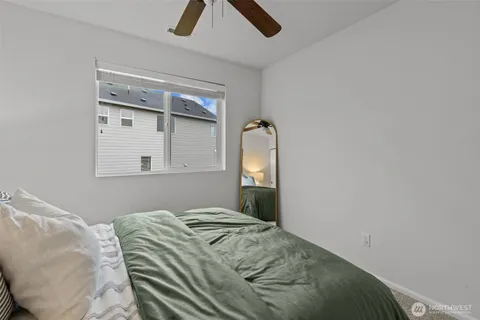 a bedroom with a bed and a mirror