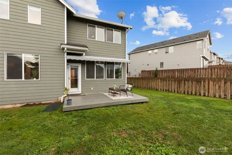 a view of a house with backyard and sitting area