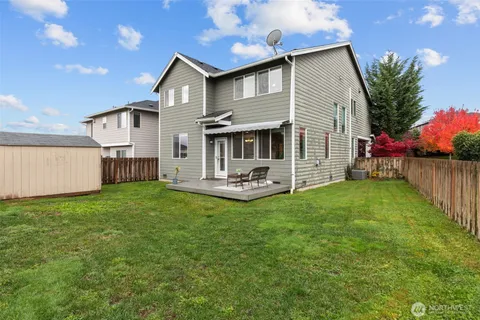a front view of a house with a garden and yard