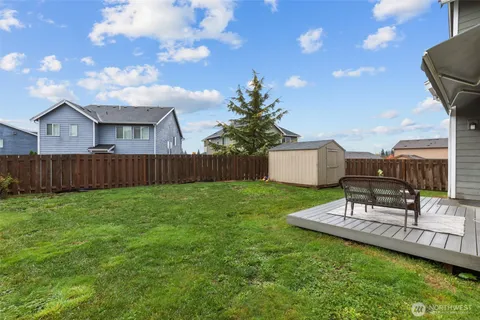 a view of a backyard with sitting area and garden