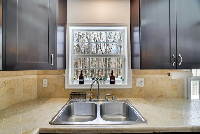 a bathroom with sink and window