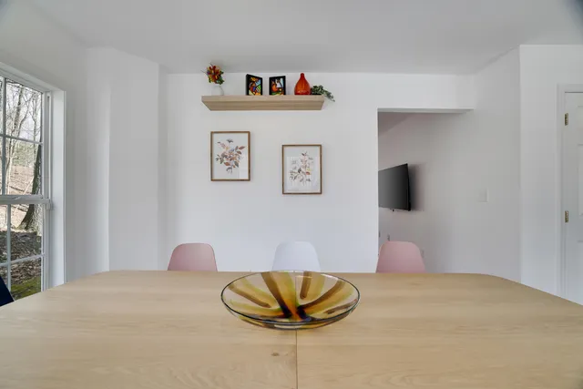 a balcony with wooden floor outdoor seating and trees in the back