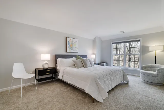 a bedroom with a bed and lamp