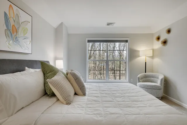 a bedroom with a bed and couch