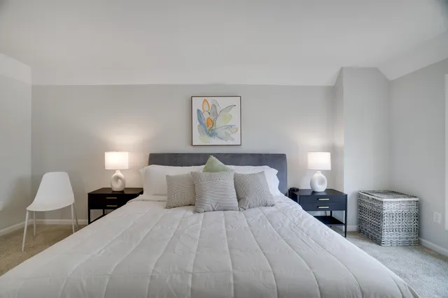 a bed room with a bed and a night stand