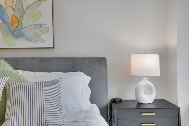 a bedroom with a bed chair and a window