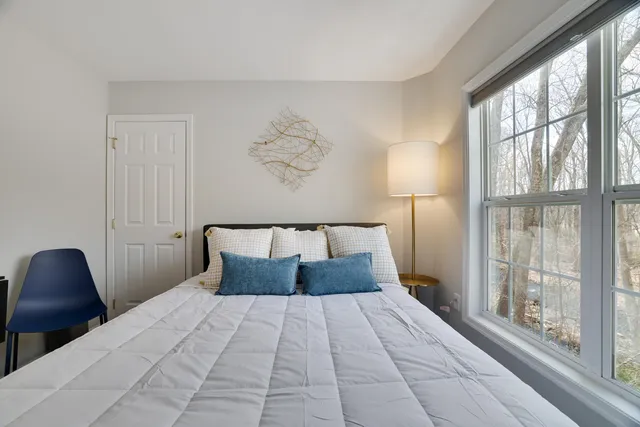 a bedroom with a bed and a window