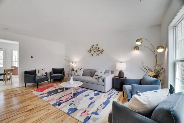 a living room with furniture and wooden floor