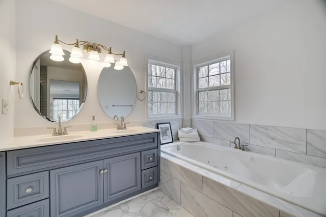 a bathroom with a granite countertop sink a toilet and a mirror