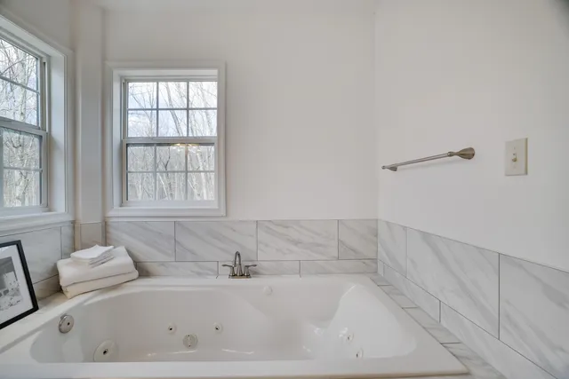 a bathroom with a granite countertop toilet sink and mirror