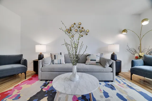 a living room with furniture and a chandelier
