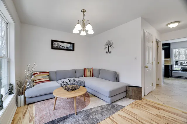 a living room with furniture and a chandelier