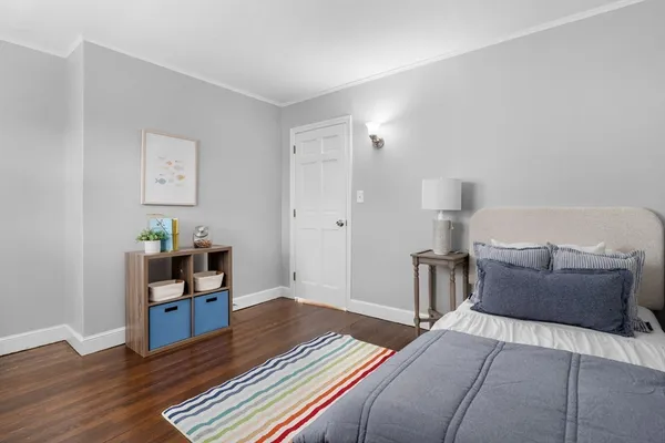 a bedroom with furniture and wooden floor