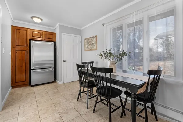 a view of a dining room with furniture and a chandelier