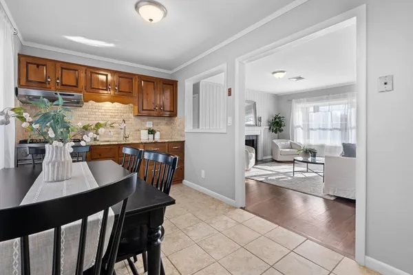 a kitchen with stainless steel appliances granite countertop counter space dining table and chairs