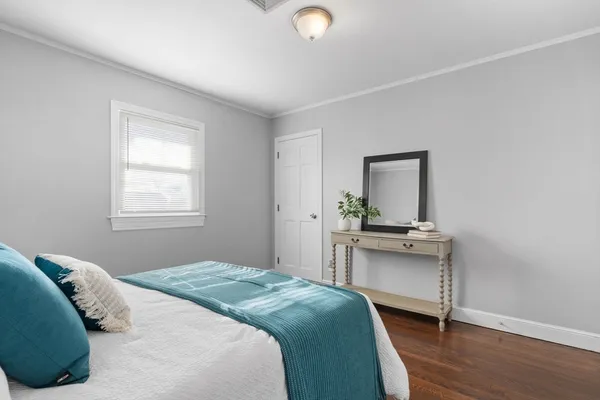 a bedroom with a bed and a desk