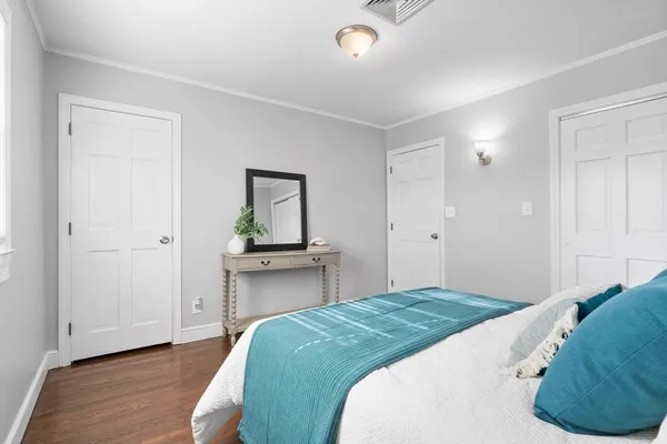 a bedroom with a bed and a dresser