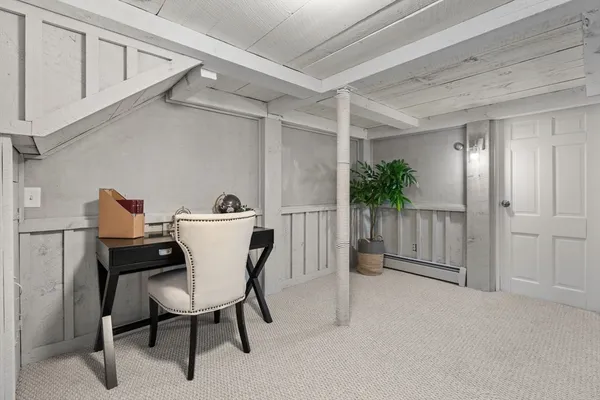a view of a room that has a table and chairs in it