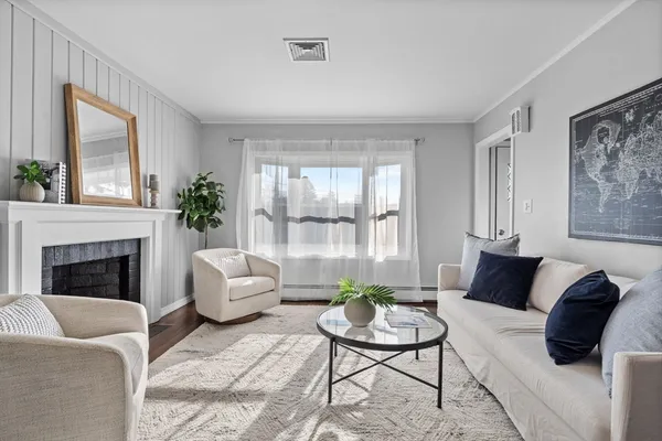 a living room with furniture and a fireplace