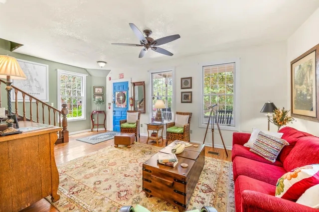 a view of a dining room with furniture and a chandelier