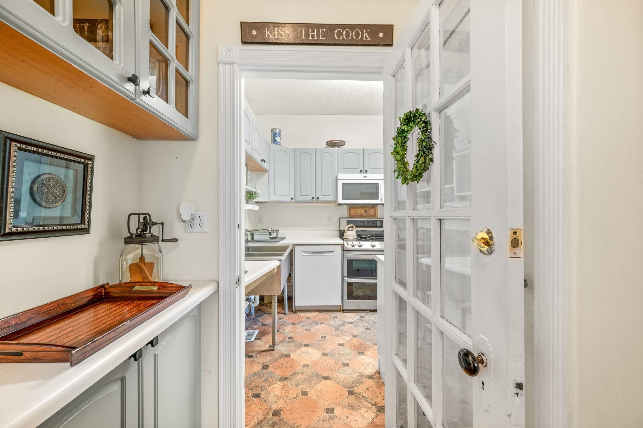 89 Cedar Street St. Augustine, FL 32084 - Photo 23 of 100 a kitchen with a refrigerator and a stove