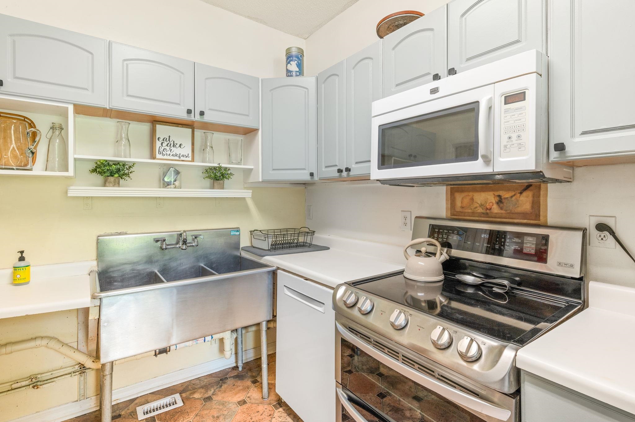 89 Cedar Street St. Augustine, FL 32084 - Photo 25 of 100 a kitchen with a stove and a microwave