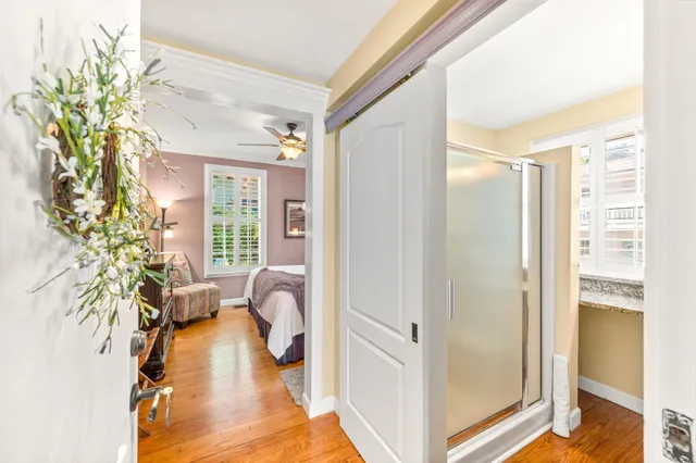 a bedroom with a bed and a flat tv screen on dresser