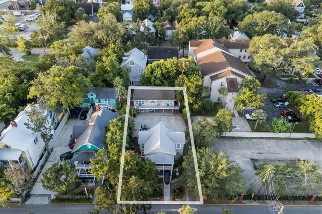 an aerial view of a house with yard swimming pool and outdoor seating