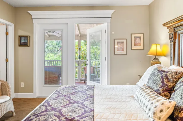 a living room with furniture and a large window with kitchen view