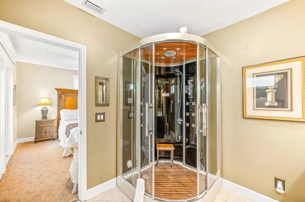 a bedroom with a bed and a flat tv screen on dresser