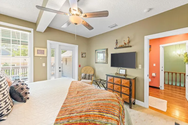a balcony with wooden floor and outdoor seating