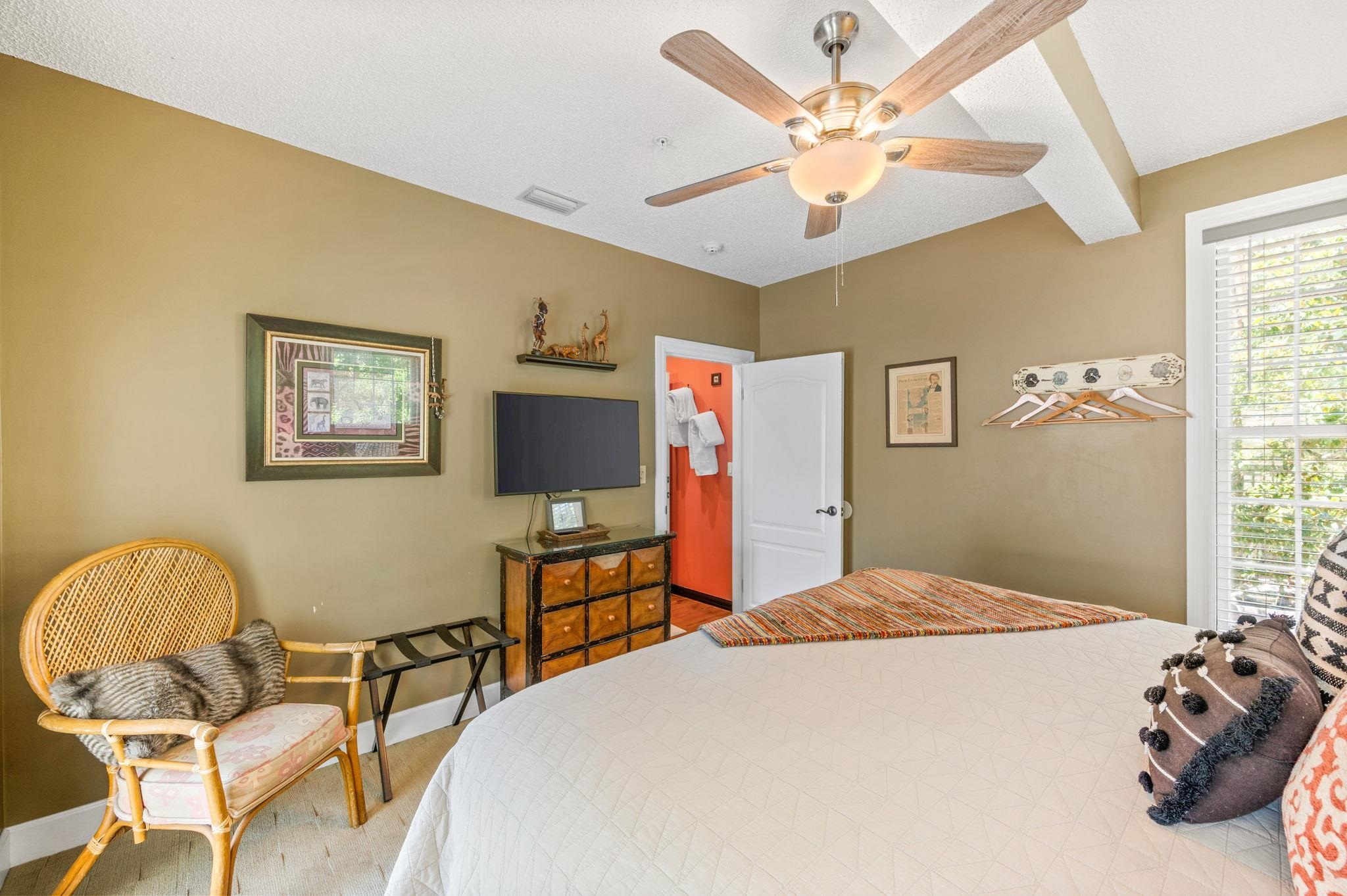 89 Cedar Street St. Augustine, FL 32084 - Photo 49 of 100 a bedroom with a bed and a chair with the large mirror