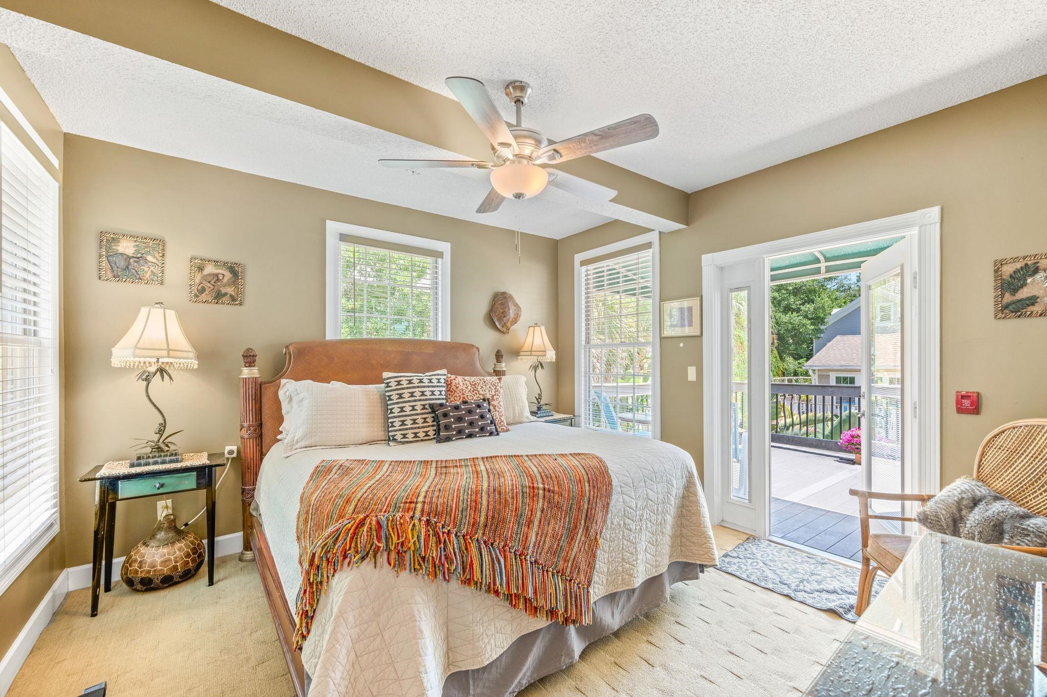 89 Cedar Street St. Augustine, FL 32084 - Photo 50 of 100 a bedroom with a large bed and a chandelier fan