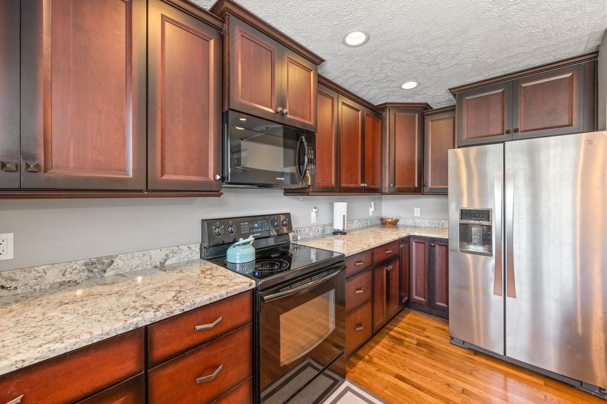89 Cedar Street St. Augustine, FL 32084 - Photo 79 of 100 a kitchen with stainless steel appliances granite countertop a refrigerator sink and cabinets