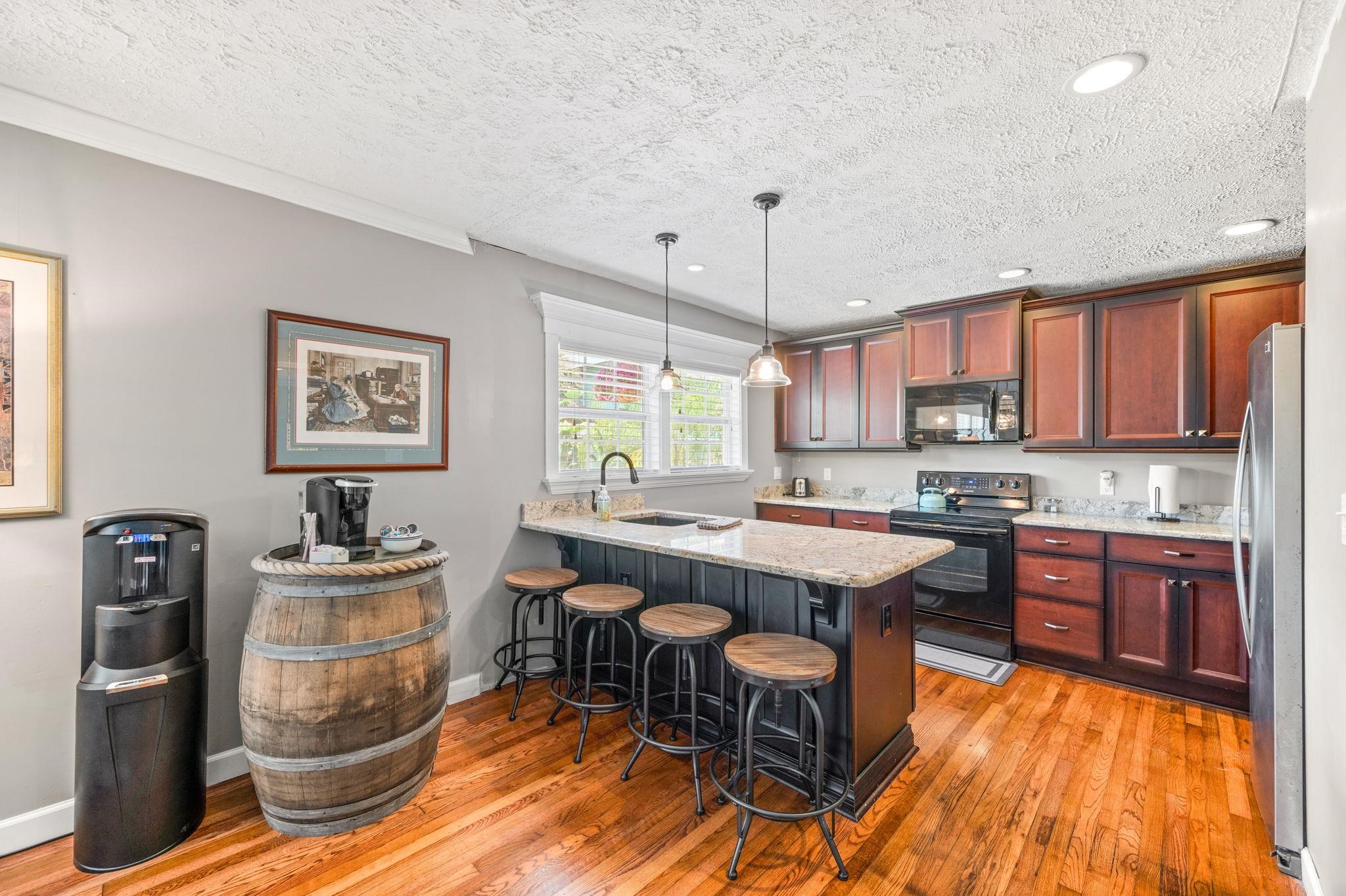 89 Cedar Street St. Augustine, FL 32084 - Photo 80 of 100 a kitchen with a stove a refrigerator and a dining table