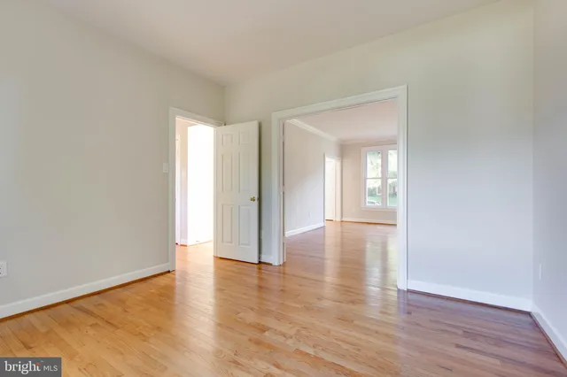 a view of a room with wooden floor staircase and a kitchen