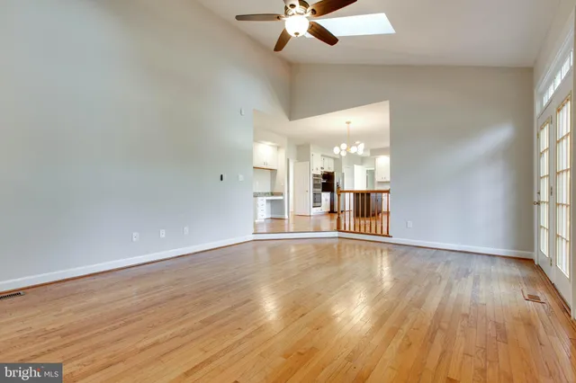 a view of livingroom with furniture wooden floor fireplace and windows