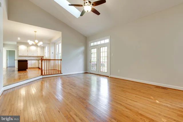 a large kitchen with stainless steel appliances granite countertop a lot of counter space and wooden floors