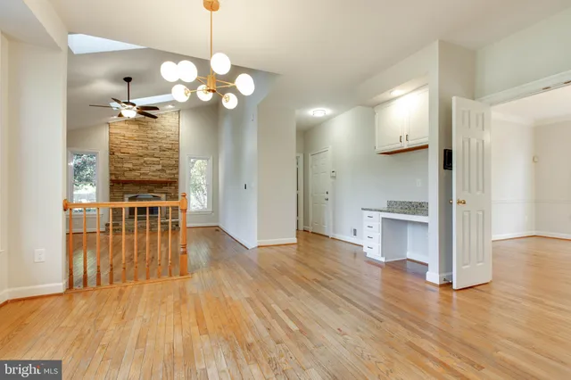 a large kitchen with stainless steel appliances granite countertop a lot of counter space and wooden floor