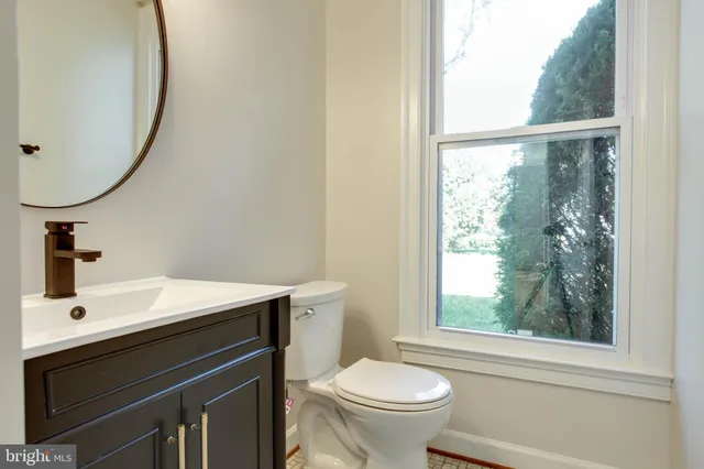 a view of a room with wooden floor and fan