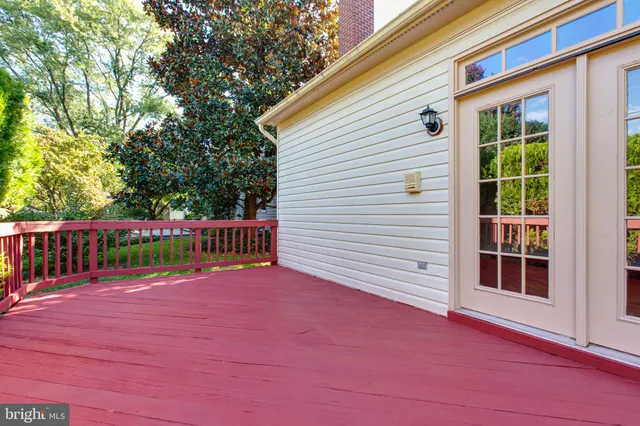 a bathroom with a granite countertop toilet a double vanity sink a mirror and a window
