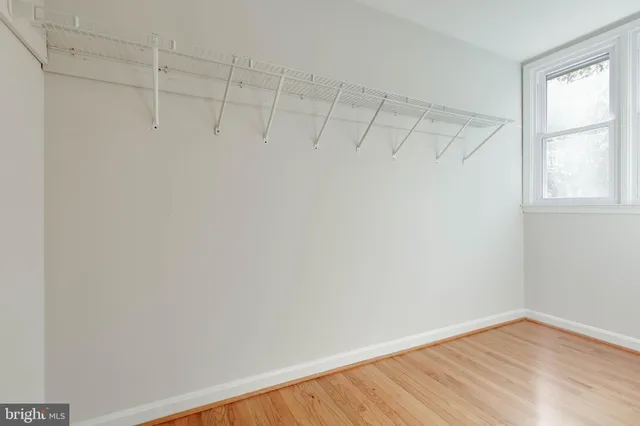 a view of an empty room and wooden floor