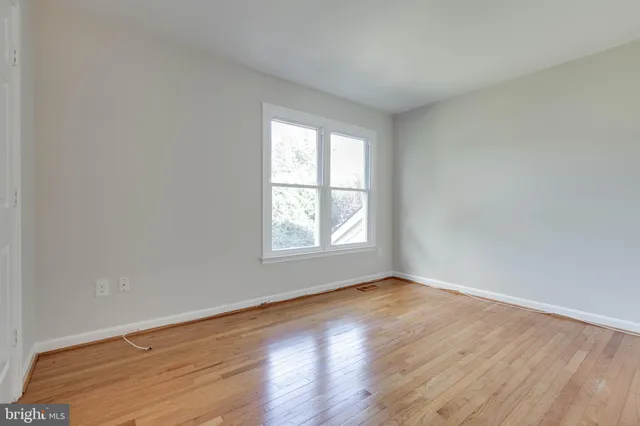 a view of an empty room and wooden floor