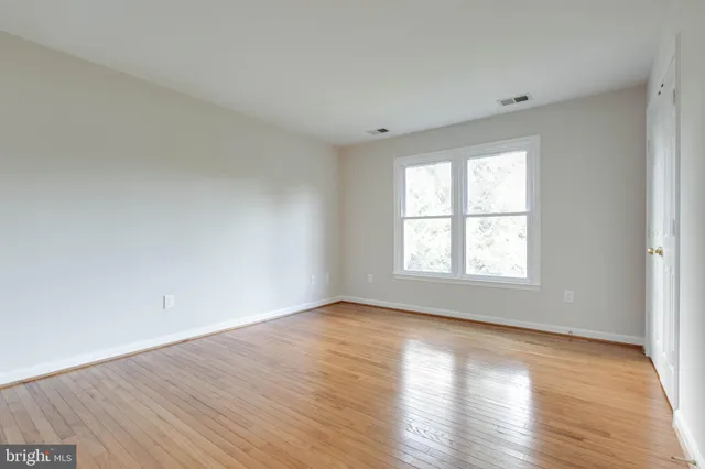a view of an empty room with closet area