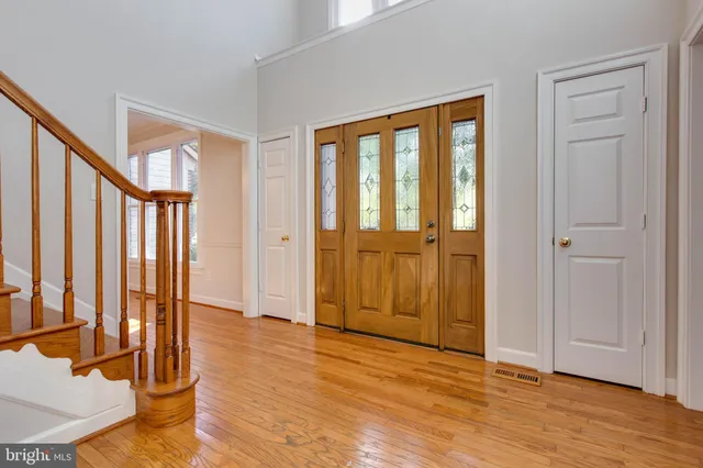 a view of entryway with wooden floor and stairs