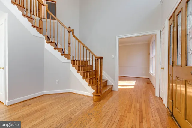 a view of an entryway with wooden floor and door