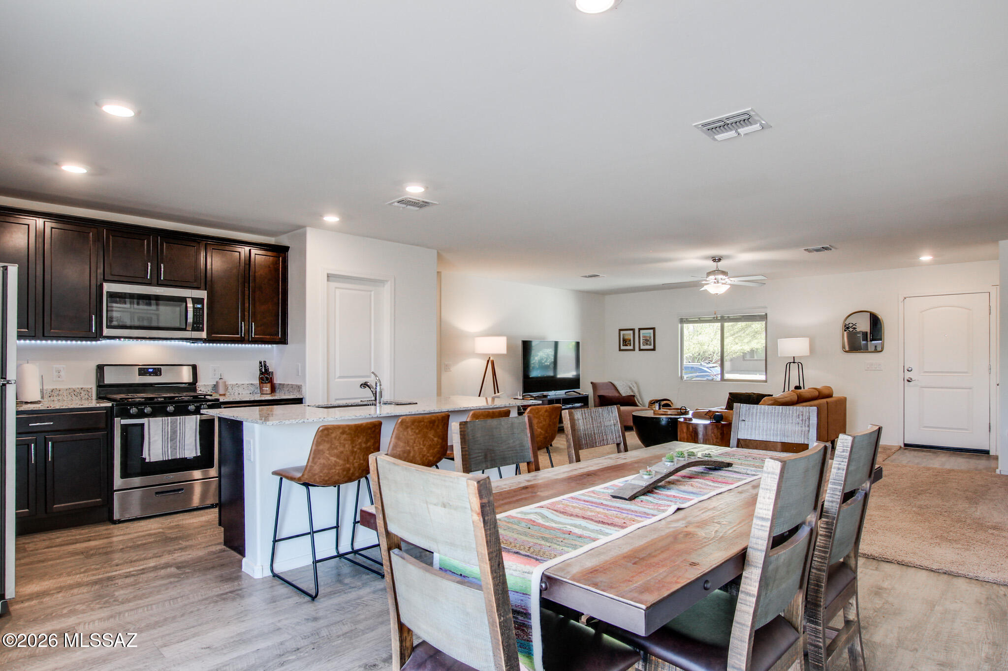 7056 South Draper Road Tucson, AZ 85757 - Photo 8 of 22 a view of a dining area with furniture and wooden floor