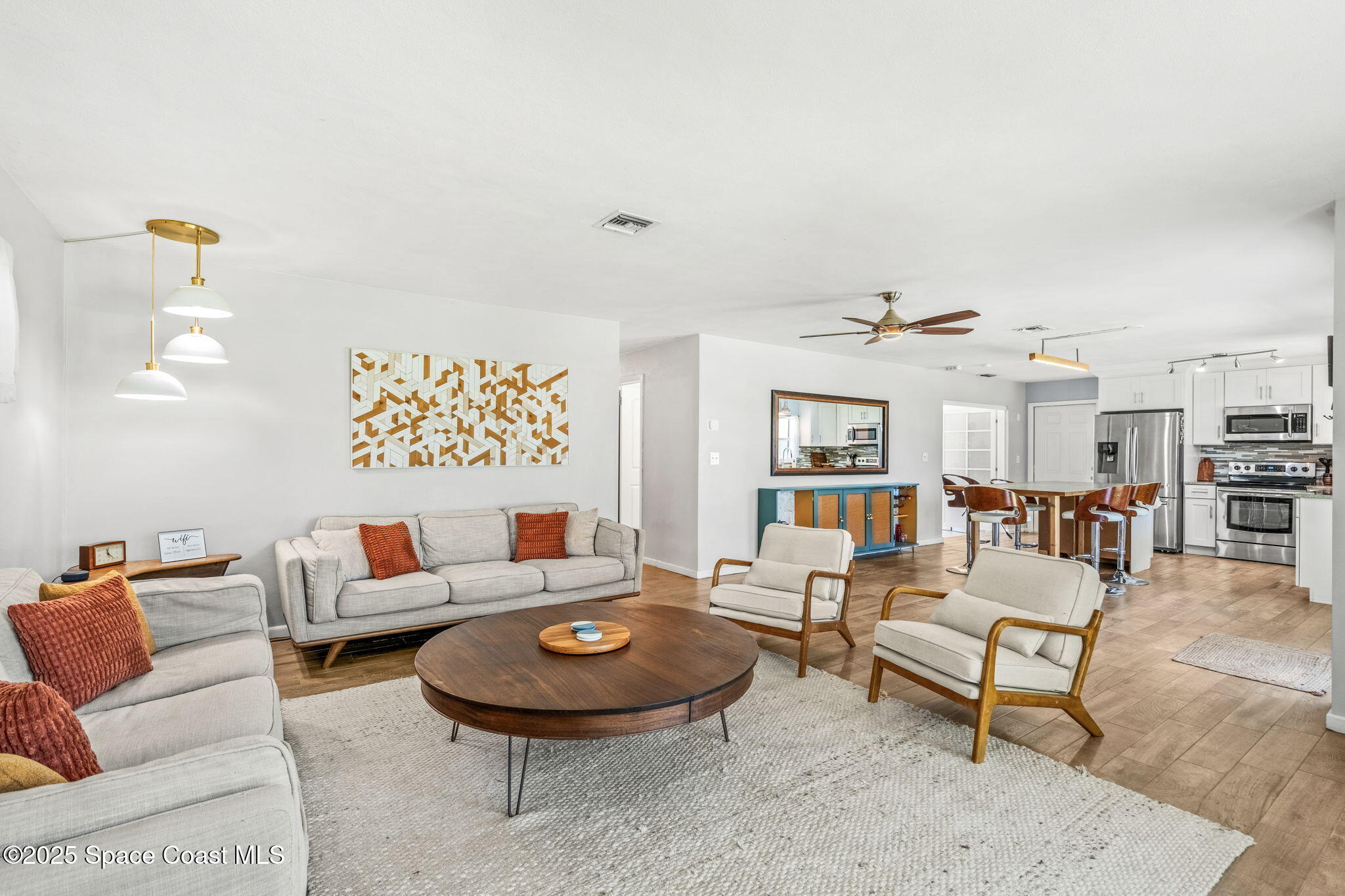 411 Poinsettia Road Melbourne Beach, FL 32951 - Photo 12 of 78 a living room with furniture and wooden floor